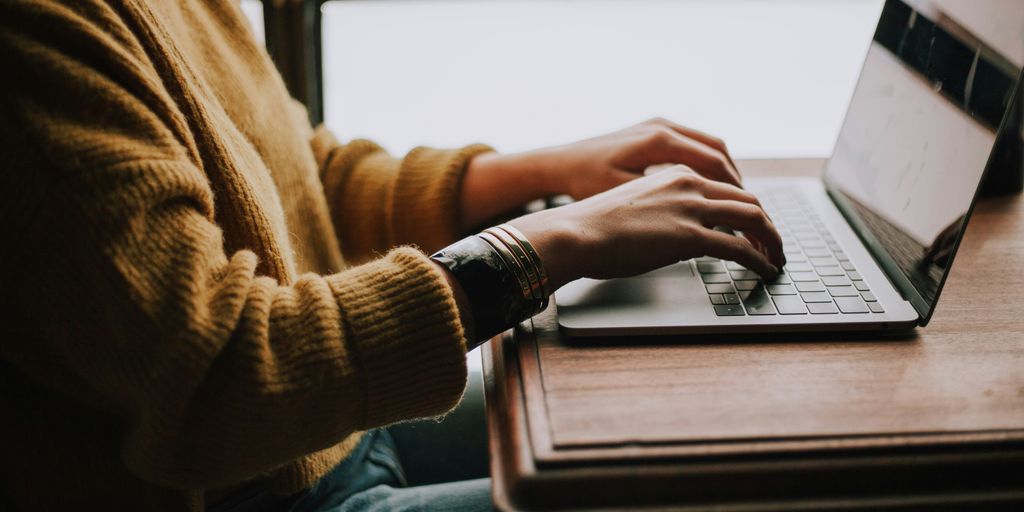 person sitting front of laptop