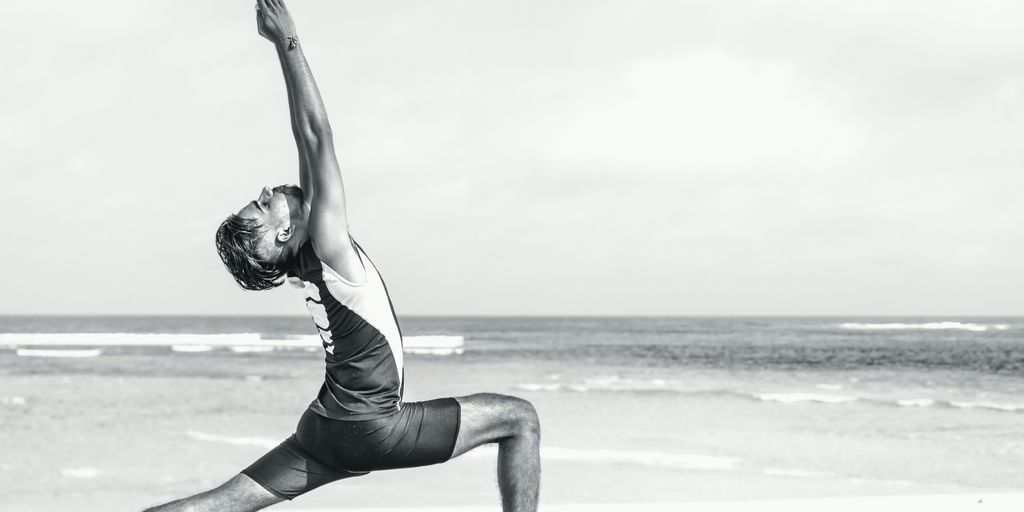 man stretching on seashore