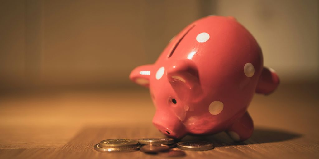 pink pig coin bank on brown wooden table